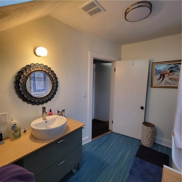 bathroom with visible vents, wood finished floors, and vanity