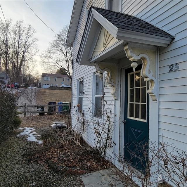 doorway to property featuring fence