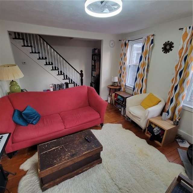 living room with stairway and wood finished floors