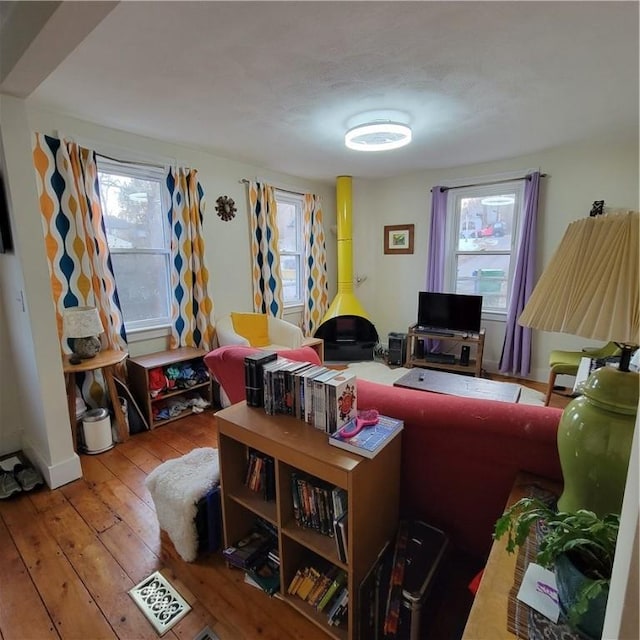 living room with a healthy amount of sunlight and hardwood / wood-style flooring