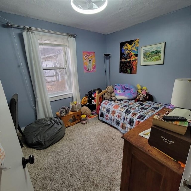 bedroom with carpet and a textured ceiling