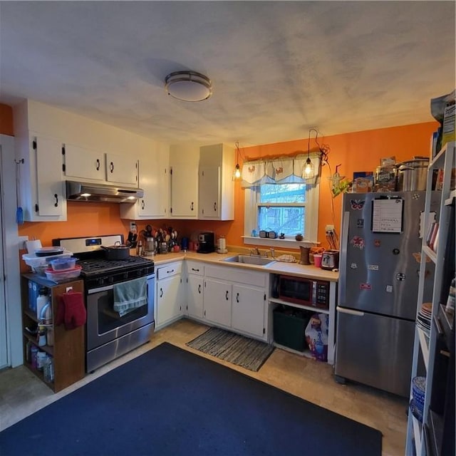 kitchen with appliances with stainless steel finishes, a sink, white cabinets, and under cabinet range hood