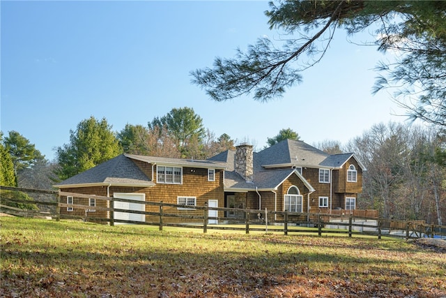 view of front of house with a fenced front yard, a chimney, and a front yard