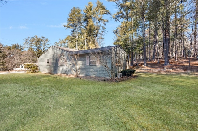 view of side of property with a lawn