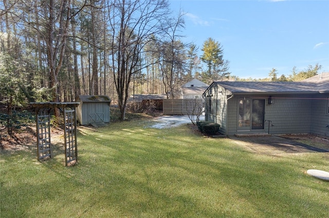 view of yard featuring a storage unit and an outbuilding