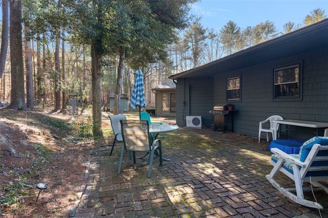 view of patio / terrace with ac unit, outdoor dining space, and area for grilling