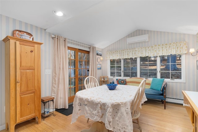 dining room with wallpapered walls, baseboard heating, vaulted ceiling, light wood-style floors, and a wall mounted AC