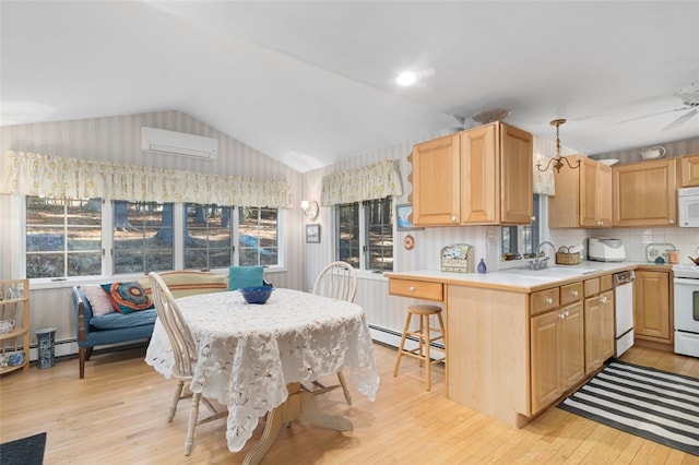 kitchen with a wall unit AC, white appliances, vaulted ceiling, light countertops, and light wood-type flooring