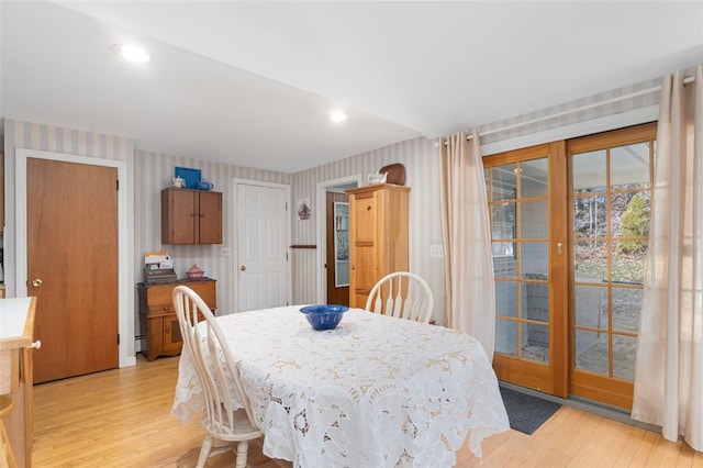 dining space with wallpapered walls, light wood finished floors, and recessed lighting