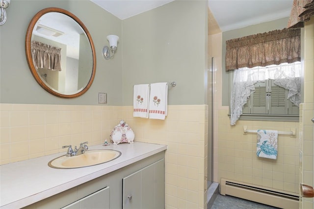 full bathroom with a wainscoted wall, tile walls, an enclosed shower, a baseboard heating unit, and vanity