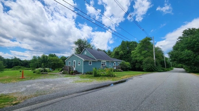 exterior space with driveway and a yard