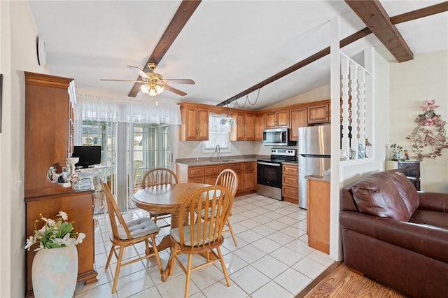 dining space featuring lofted ceiling with beams, light tile patterned flooring, and a ceiling fan