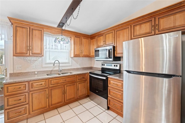 kitchen with brown cabinetry, appliances with stainless steel finishes, pendant lighting, a sink, and light tile patterned flooring