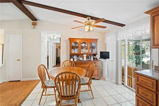 dining space with lofted ceiling with beams, light tile patterned floors, and ceiling fan