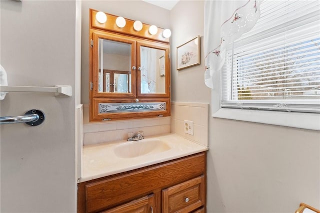 bathroom with vanity and decorative backsplash