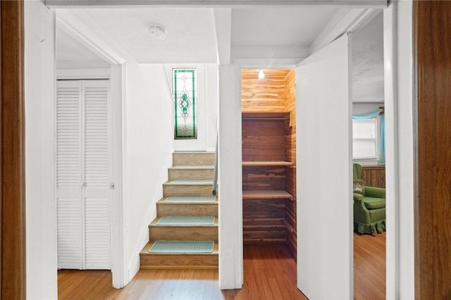 stairway with wood finished floors and baseboards