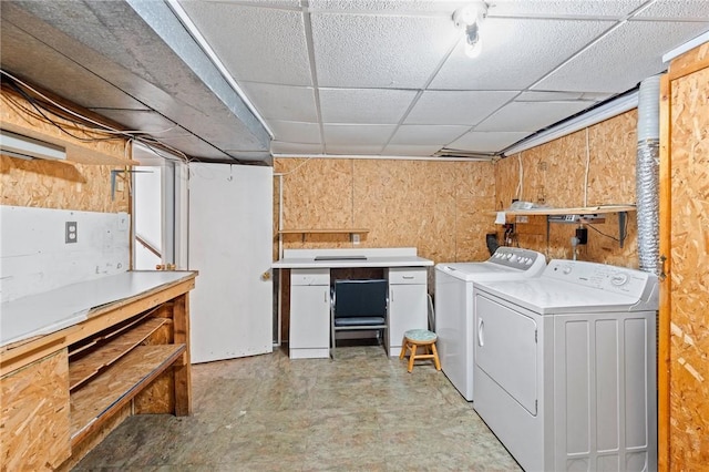 washroom with wooden walls, laundry area, and washer and clothes dryer