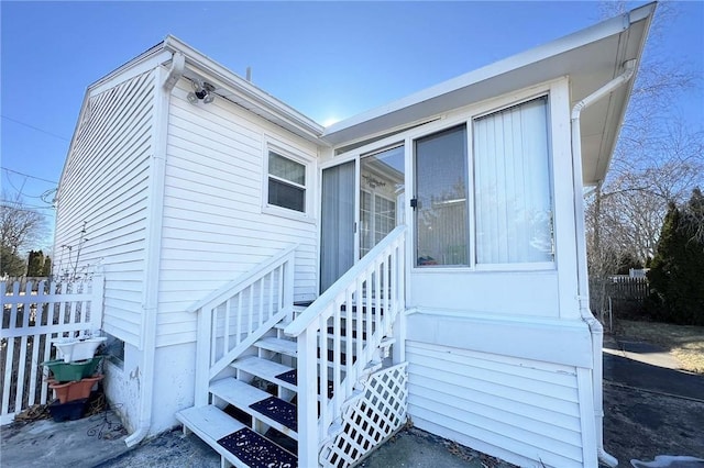 view of exterior entry with fence