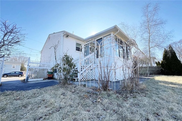 view of property exterior with fence