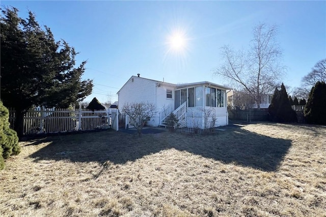 exterior space featuring a sunroom and fence