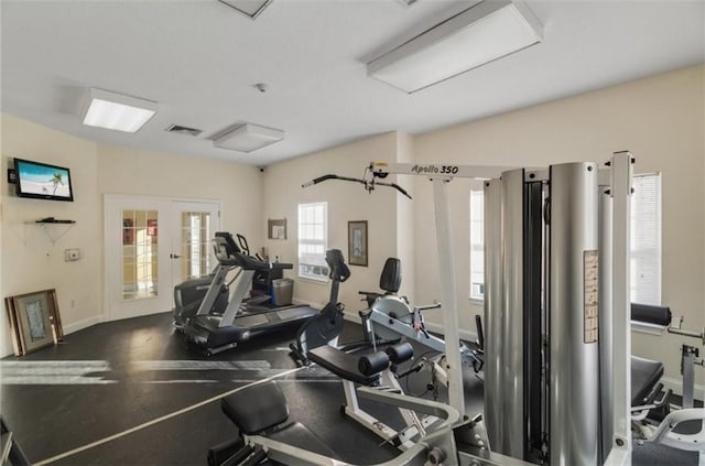 gym with visible vents, baseboards, and french doors