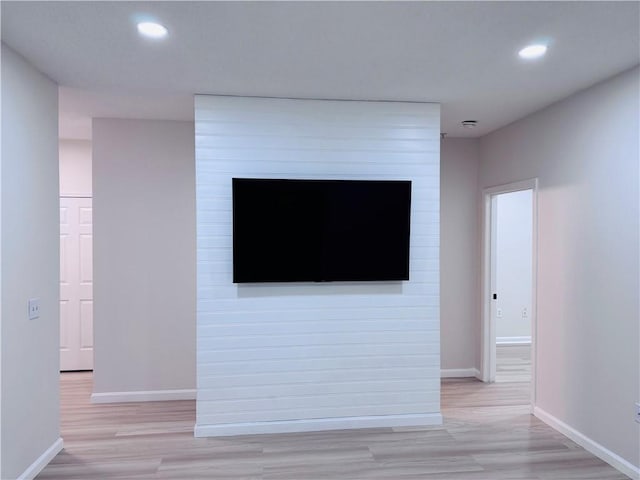 interior space featuring baseboards, wood finished floors, and recessed lighting