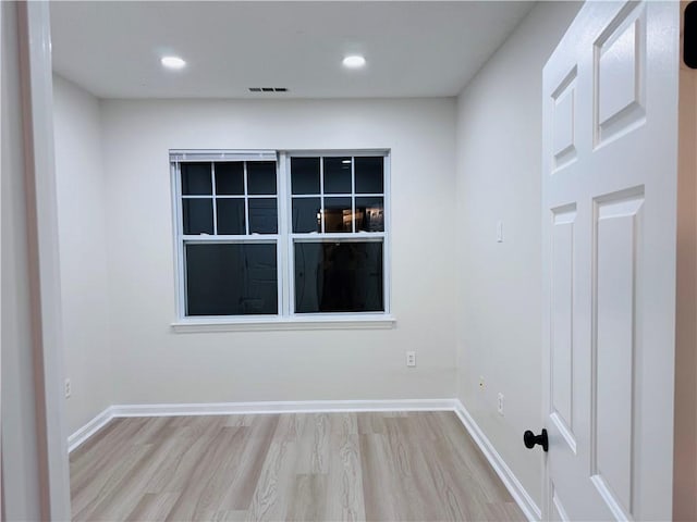 spare room featuring baseboards, visible vents, wood finished floors, and recessed lighting