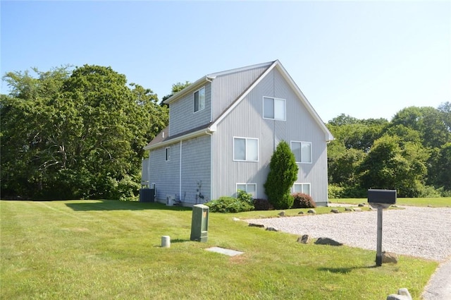 view of property exterior featuring central AC and a lawn