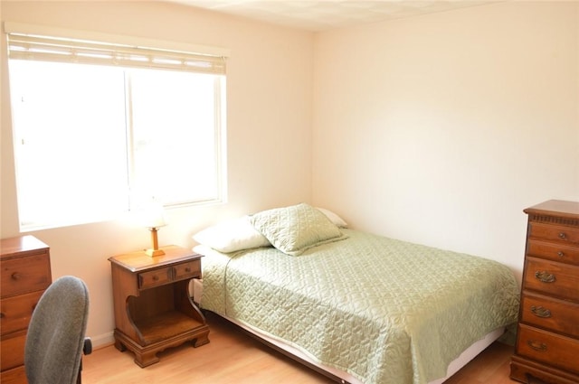 bedroom with light wood finished floors