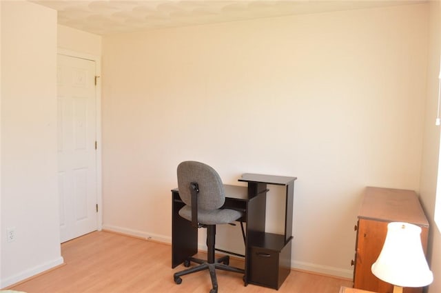 office space featuring baseboards and wood finished floors