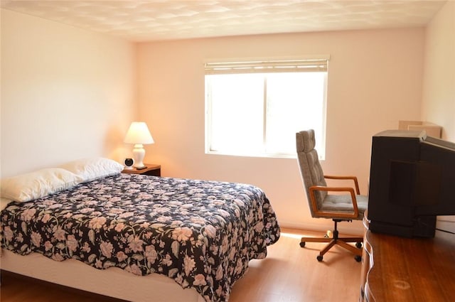 bedroom featuring wood finished floors