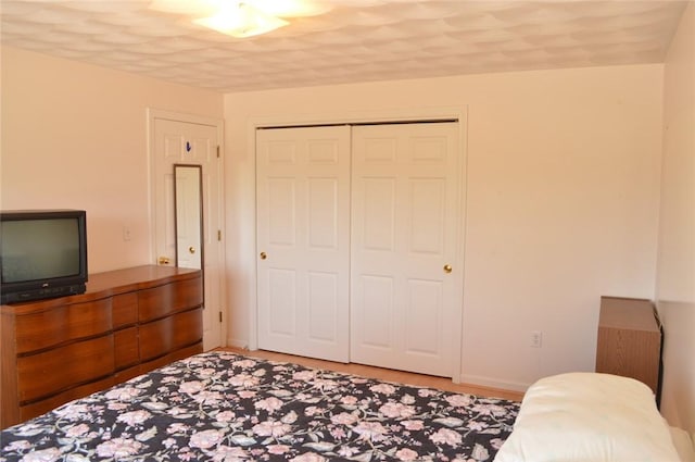 bedroom with a closet and baseboards