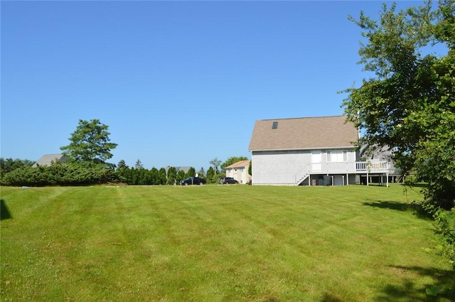 view of yard with stairway and a deck