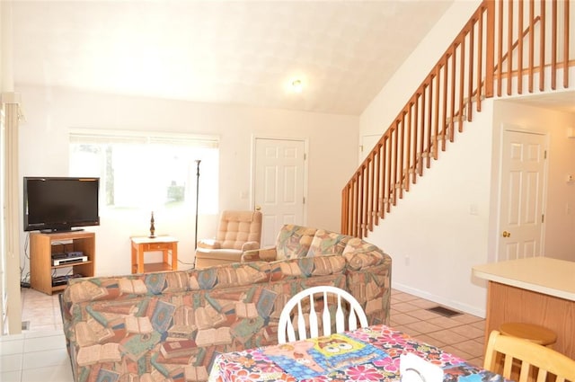 dining room with tile patterned flooring, visible vents, stairway, and baseboards