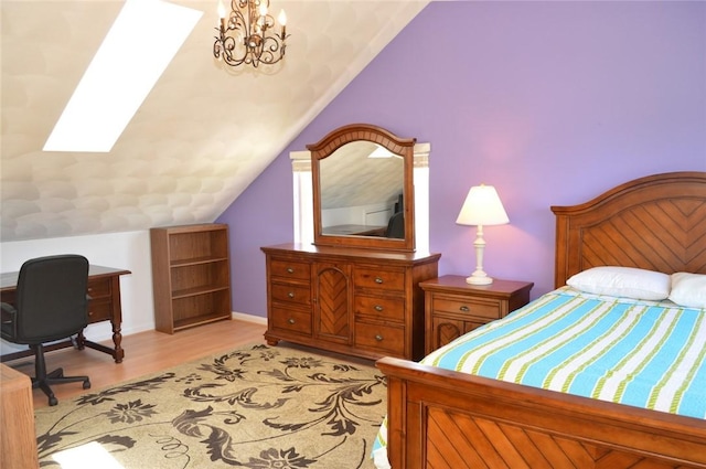 bedroom with vaulted ceiling with skylight, light wood-type flooring, and a notable chandelier