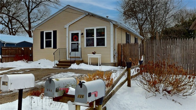 bungalow-style home featuring fence