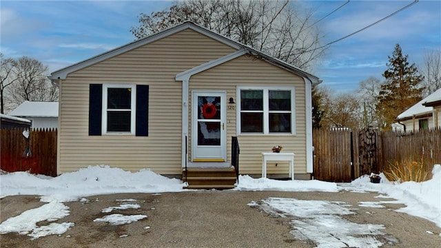 bungalow with entry steps and fence