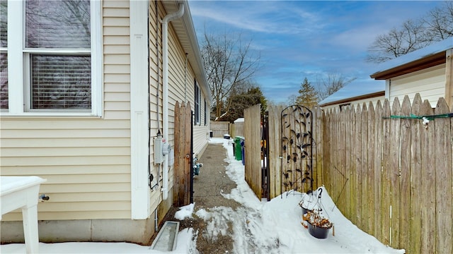 view of snowy exterior with fence