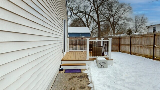 snow covered deck with fence