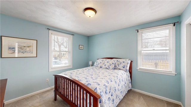 carpeted bedroom featuring baseboards