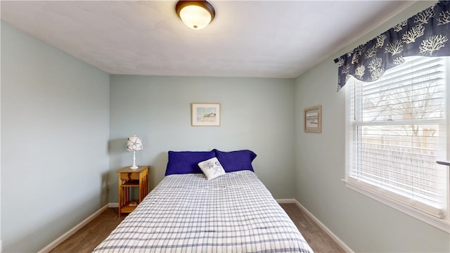 carpeted bedroom featuring baseboards