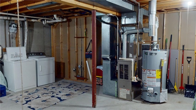 unfinished basement featuring water heater, washing machine and dryer, and heating unit