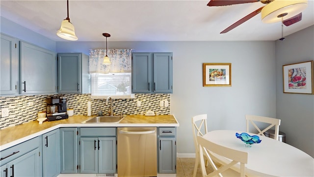 kitchen featuring a sink, tasteful backsplash, light countertops, and dishwasher