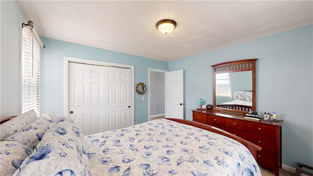 bedroom featuring a closet and baseboards