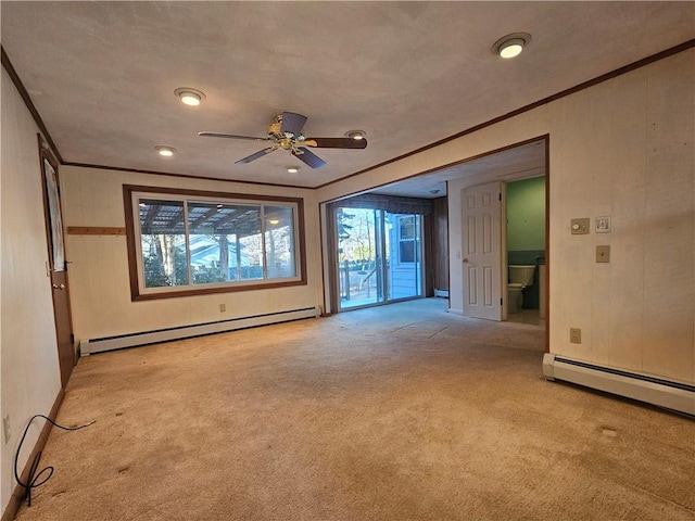 unfurnished room with light carpet, baseboard heating, and crown molding