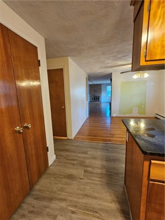 hall with baseboards and dark wood-style flooring