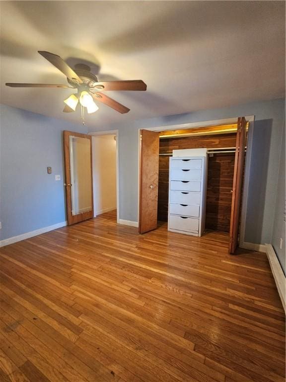 unfurnished bedroom with wood finished floors, a ceiling fan, and baseboards