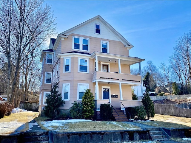 view of front of home featuring a balcony and fence