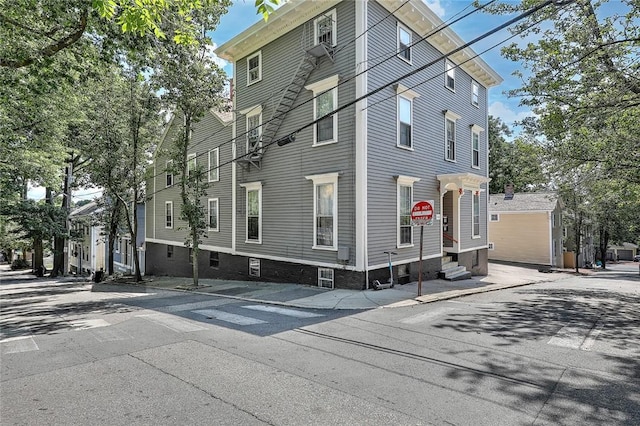 view of side of property with entry steps