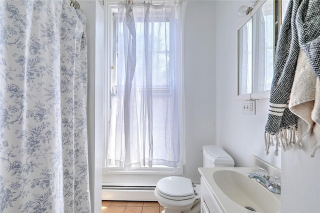 full bath featuring toilet, a baseboard radiator, vanity, and tile patterned floors